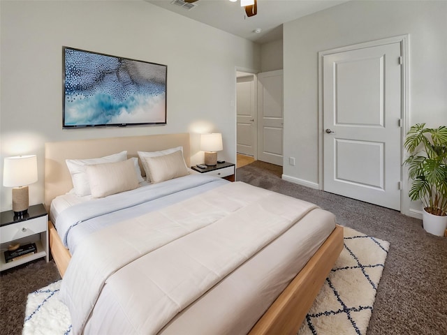 carpeted bedroom featuring a ceiling fan, visible vents, and baseboards