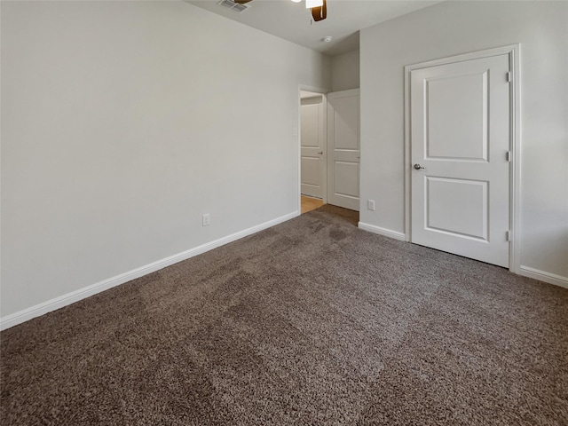 unfurnished bedroom with ceiling fan, carpet, visible vents, and baseboards