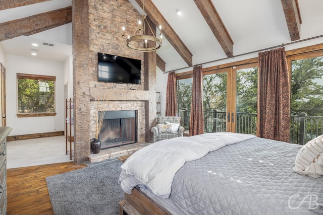 bedroom featuring a fireplace, visible vents, beam ceiling, and wood finished floors