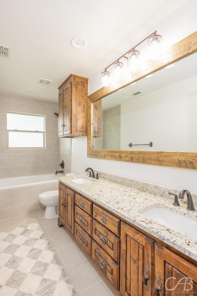 bathroom with a sink, visible vents, and tile patterned floors