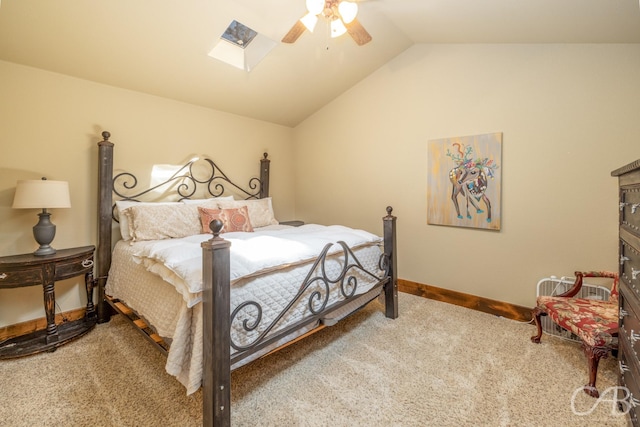 carpeted bedroom with lofted ceiling with skylight, ceiling fan, and baseboards