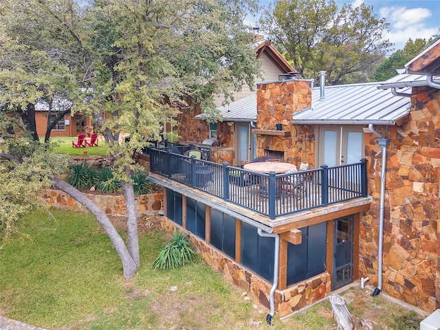 exterior space featuring a standing seam roof, metal roof, a yard, and a chimney