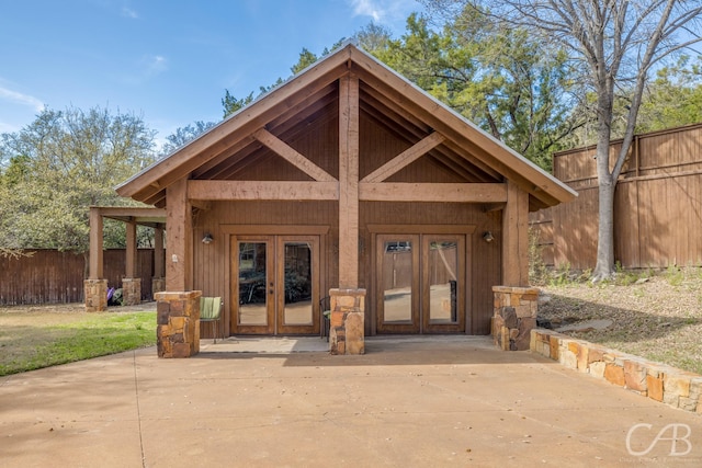 exterior space featuring french doors and fence