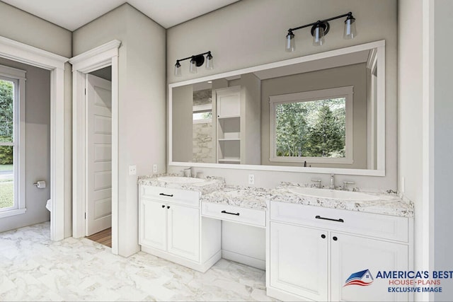 full bath with a healthy amount of sunlight, marble finish floor, and a sink