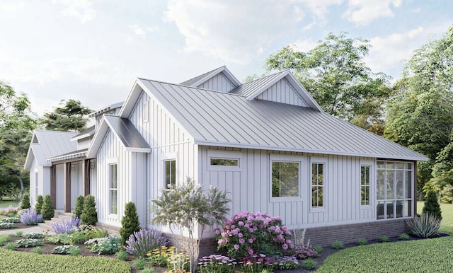 view of property exterior featuring board and batten siding, a standing seam roof, brick siding, and metal roof