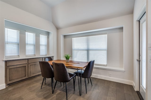 dining area with a wealth of natural light, baseboards, lofted ceiling, and dark wood-style floors