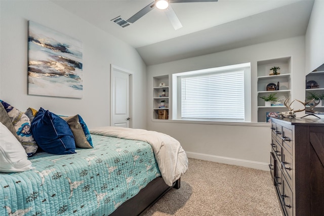 bedroom with visible vents, baseboards, light colored carpet, vaulted ceiling, and a ceiling fan