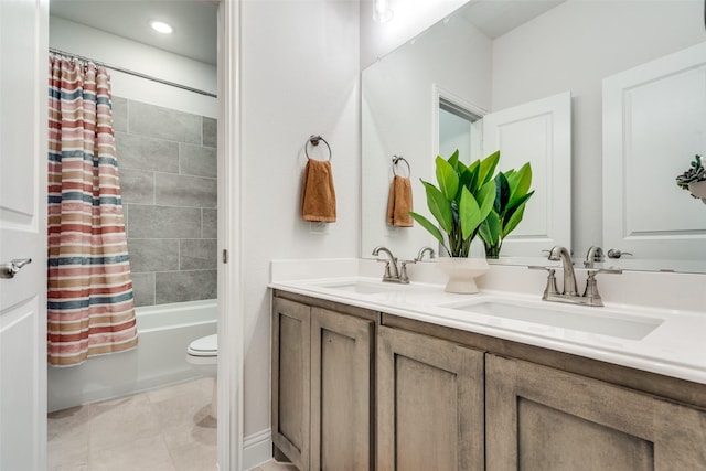 full bathroom with double vanity, toilet, shower / tub combo with curtain, and a sink