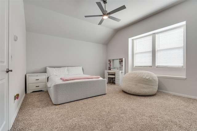 bedroom with carpet flooring, baseboards, lofted ceiling, and a ceiling fan