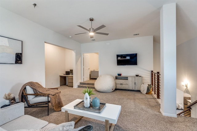 living room featuring visible vents, baseboards, ceiling fan, and carpet flooring