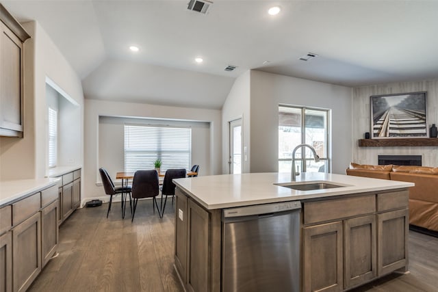 kitchen featuring dark wood-style floors, a sink, visible vents, and stainless steel dishwasher