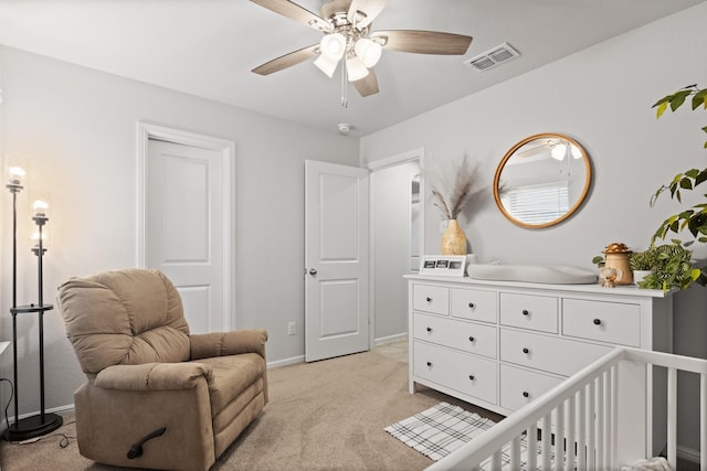 living area with a ceiling fan, visible vents, light carpet, and baseboards