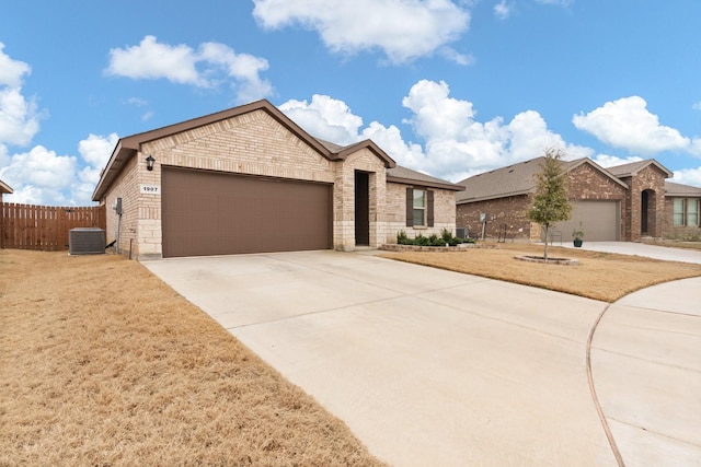 single story home featuring a garage, concrete driveway, fence, cooling unit, and brick siding