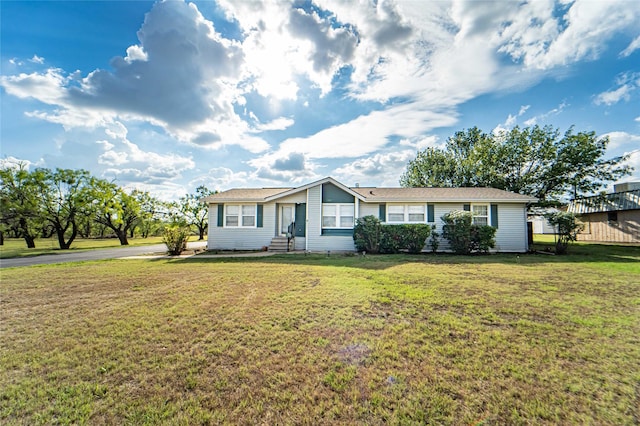 single story home with entry steps and a front lawn