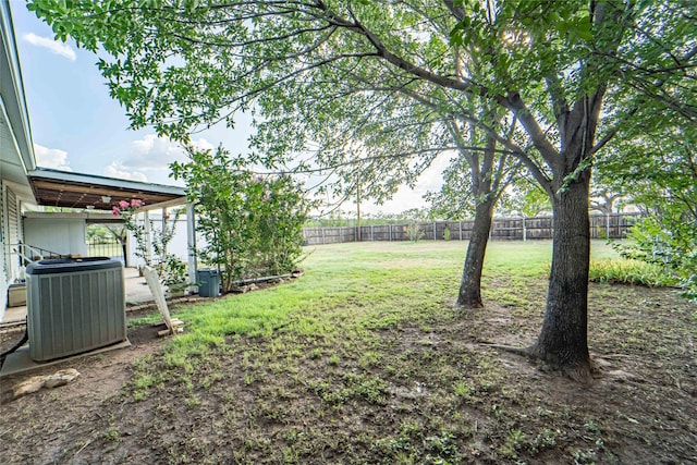 view of yard featuring central air condition unit and a fenced backyard