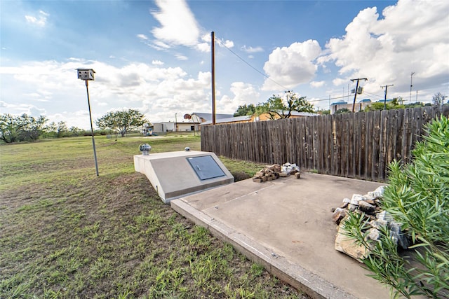 view of storm shelter with fence and a lawn