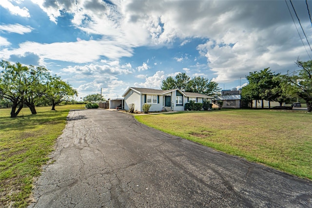 view of front of property with a front yard and driveway