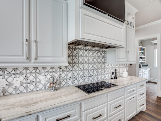 kitchen featuring black electric stovetop, white cabinetry, backsplash, dark wood-style floors, and crown molding