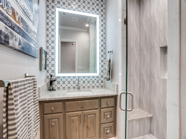 full bath with visible vents, ornamental molding, a shower stall, and vanity