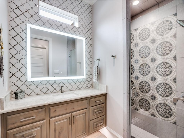 full bath featuring tasteful backsplash, a tile shower, and vanity