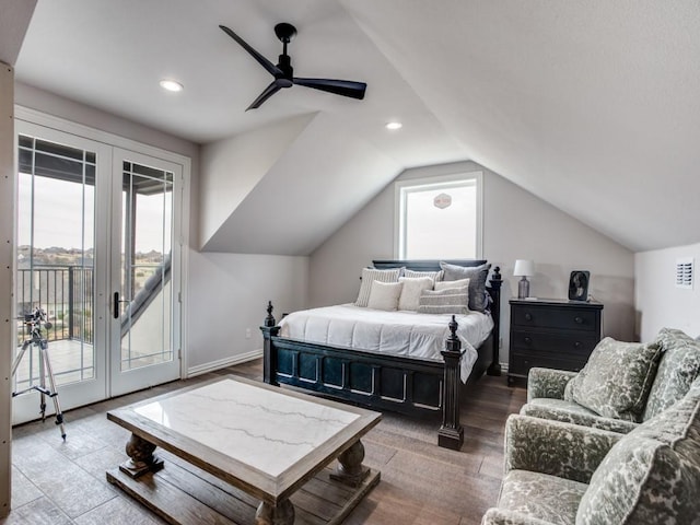 bedroom featuring access to outside, multiple windows, vaulted ceiling, and wood finished floors