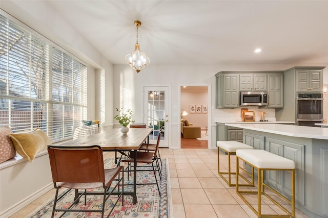 dining space with recessed lighting, baseboards, a chandelier, and light tile patterned flooring