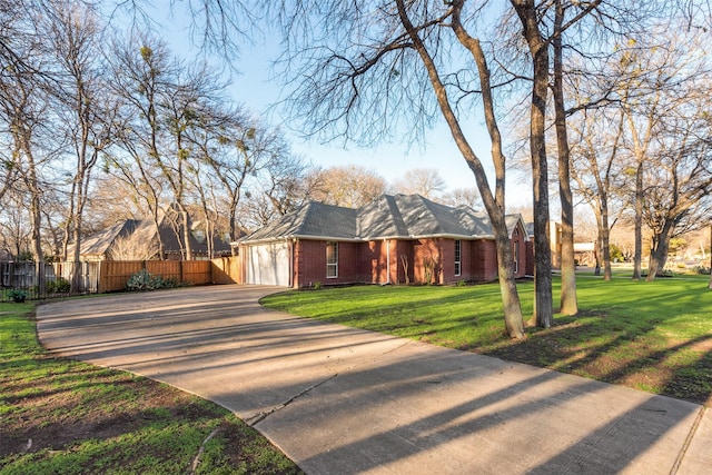 view of front of property featuring a garage, brick siding, fence, concrete driveway, and a front lawn