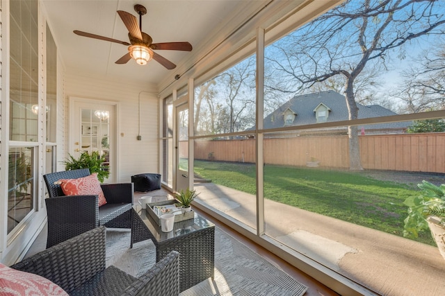 sunroom featuring a ceiling fan