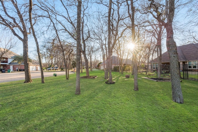 surrounding community featuring a lawn and fence