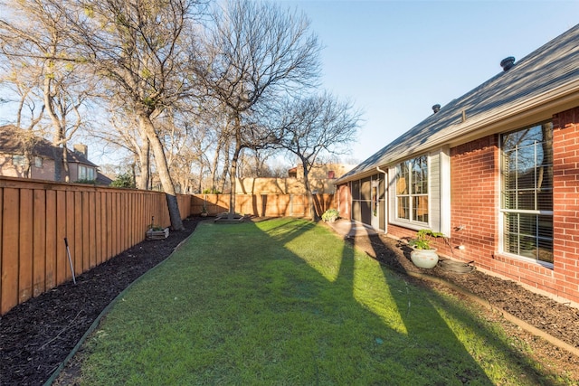 view of yard with a fenced backyard