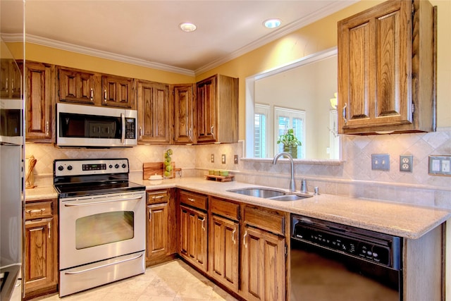 kitchen with crown molding, appliances with stainless steel finishes, a sink, and brown cabinets