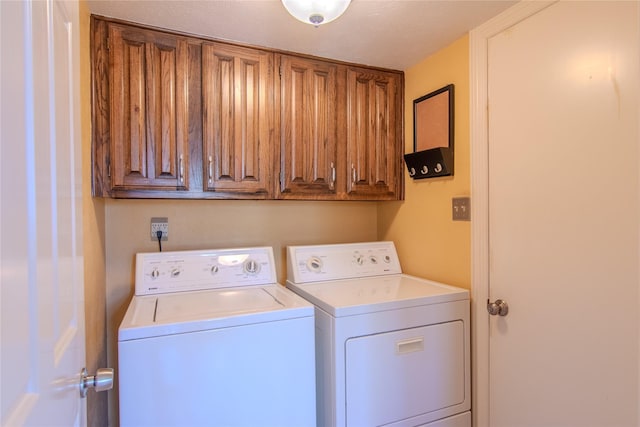 laundry area with washing machine and dryer and cabinet space