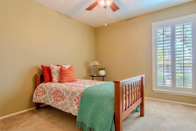 bedroom with a ceiling fan, carpet, and baseboards