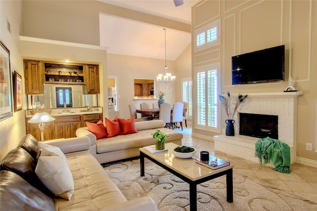 living area featuring a fireplace, an inviting chandelier, light tile patterned flooring, high vaulted ceiling, and baseboards