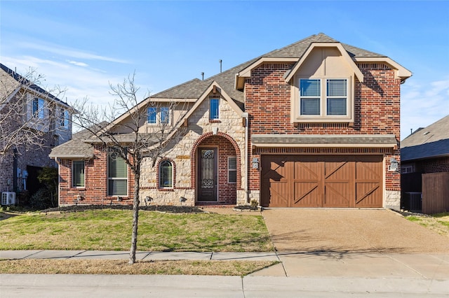 view of front of house featuring a garage, stone siding, brick siding, and concrete driveway