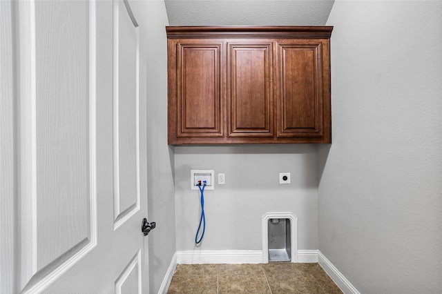 laundry area featuring hookup for a washing machine, baseboards, cabinet space, tile patterned floors, and electric dryer hookup