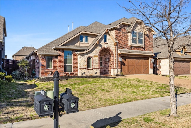 view of front of home with stone siding, brick siding, an attached garage, and driveway