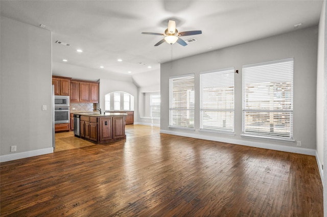 unfurnished living room with baseboards, visible vents, a ceiling fan, wood finished floors, and recessed lighting