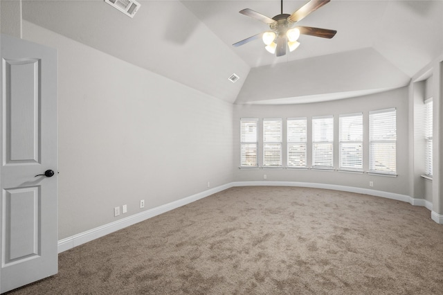 spare room with carpet floors, visible vents, vaulted ceiling, ceiling fan, and baseboards