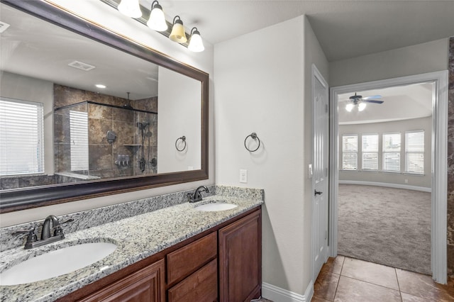 full bathroom with a tile shower, a sink, visible vents, and tile patterned floors