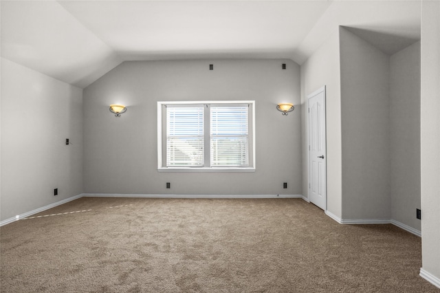 bonus room with lofted ceiling, baseboards, and carpet