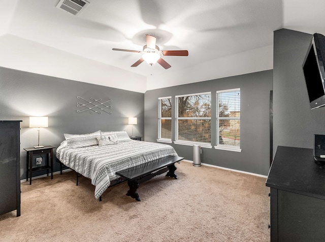 carpeted bedroom with a ceiling fan, visible vents, vaulted ceiling, and baseboards