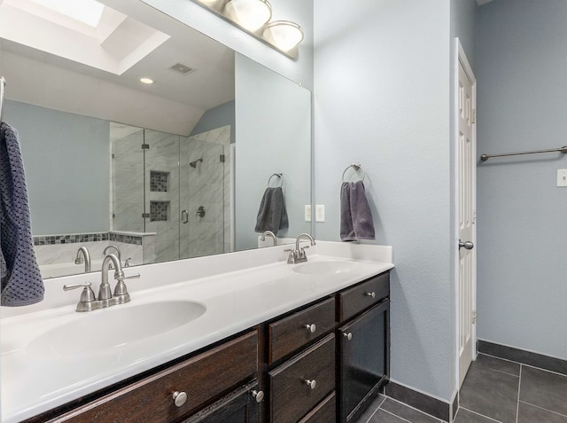 full bathroom featuring double vanity, a sink, a shower stall, and tile patterned floors