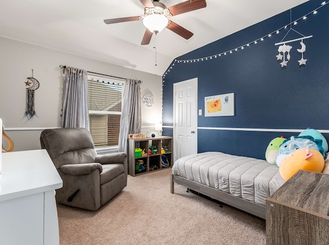 carpeted bedroom with lofted ceiling and a ceiling fan