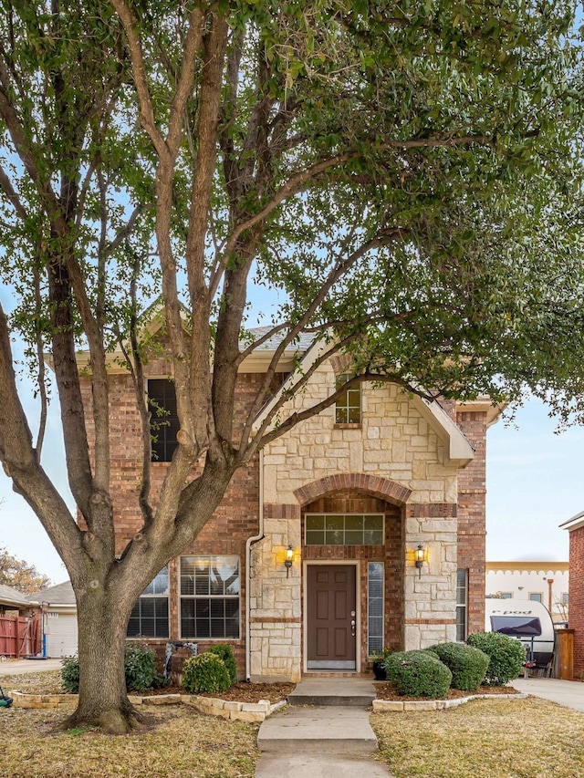 view of front of property featuring stone siding and brick siding