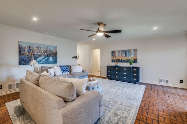 living room featuring visible vents, crown molding, and baseboards