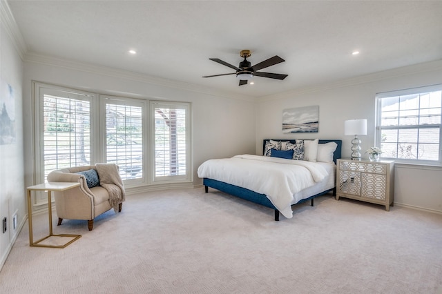 bedroom with light carpet, ceiling fan, baseboards, and crown molding