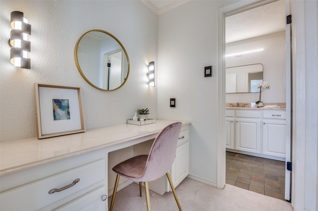 bathroom featuring crown molding, vanity, and baseboards