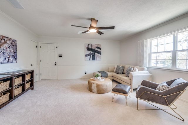 living room with carpet flooring, a ceiling fan, and crown molding