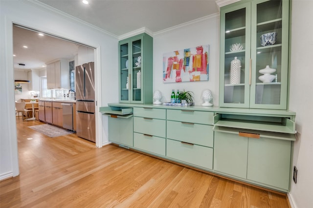 bar with appliances with stainless steel finishes, recessed lighting, crown molding, and light wood-style flooring